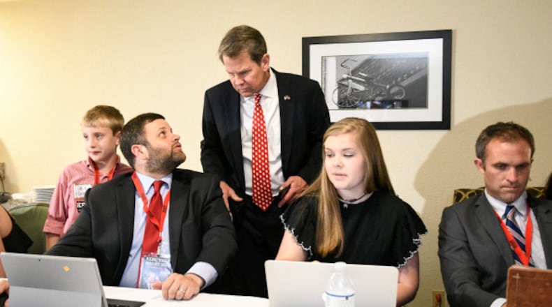 Tim Fleming chats with Gov. Brian Kemp as they monitor election results in May 2018. (AP Photo/John Amis)