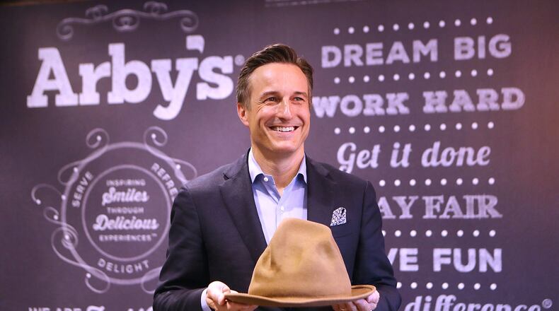 Arby’s CEO Paul Brown, holding a hat Pharrell Williams wore during the 2014 Grammy Awards, says playful products and marketing have paid off for the Atlanta fast-food chain. The hat, which Arby’s bought for $49,000, resembles Arby’s logo. Curtis Compton/ccompton@ajc.com