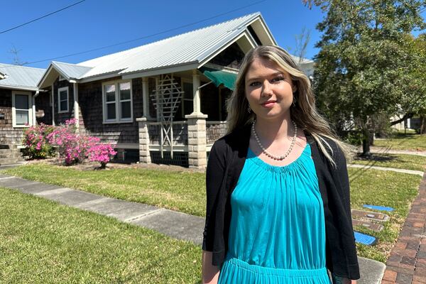 Aliyah Meyer, an official with the St. Johns County Chamber of Commerce, walks through a downtown neighborhood in St. Augustine, Fla., which has become a top remote work hub in the U.S. during the 2020s, on Thursday, March 13, 2025. (AP Photo/Mike Schneider.)