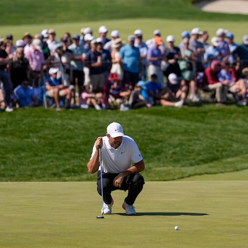 Scottie Scheffler lines up his shot on the 10th green during the third round of the PGA Championship golf tournament at Aronimink Golf Club, Saturday, May 16, 2026, in Newtown Square, PA. (AP Photo/Matt Slocum)