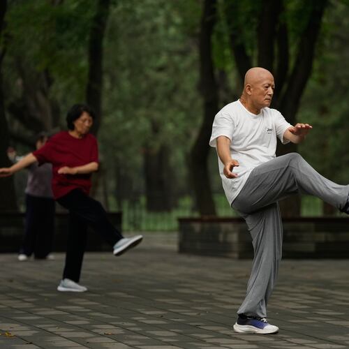 People practice Tai Chi at a park near the Temple of Heaven in Beijing, Thursday July 9, 2026. (AP Photo/Andy Wong)