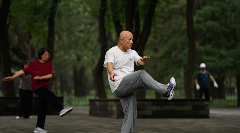 People practice Tai Chi at a park near the Temple of Heaven in Beijing, Thursday July 9, 2026. (AP Photo/Andy Wong)