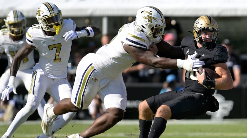 Central Florida quarterback John Rhys Plumlee (10) is sacked by Georgia Tech defensive lineman Keion White, second from right, during the first half of an NCAA college football game, Saturday, Sept. 24, 2022, in Orlando, Fla. (AP Photo/Phelan M. Ebenhack)