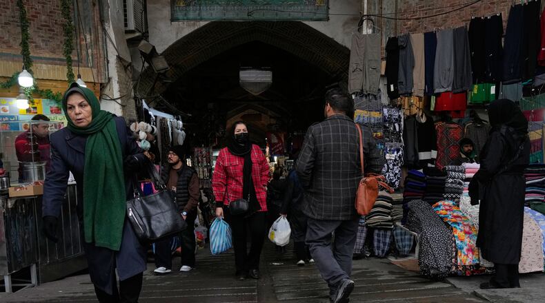 People walk at Tehran's historic Grand Bazaar, Tuesday, Jan. 20, 2026, in Iran. (AP Photo/Vahid Salemi)