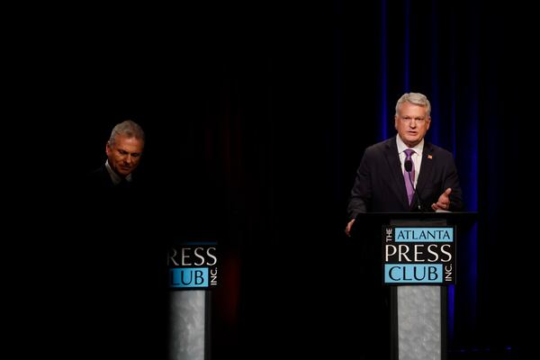 U.S. Rep. Mike Collins, R-Jackson, right, responds to a question at the Atlanta Press Club Loudermilk-Young debate for the U.S. Senate at Georgia Public Broadcasting in Midtown on Sunday, April 26, 2026.  (Miguel Martinez/AJC)