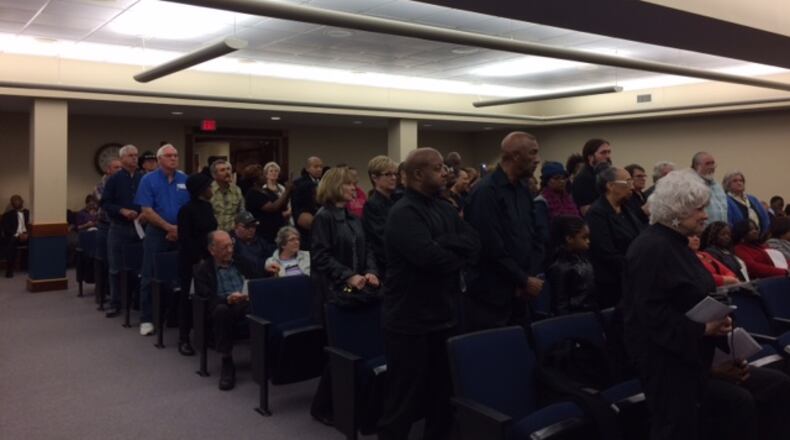 More than 70 Clayton residents stand during Tuesday’s commission meeting to protect commissioners’ recent decision to stop airing the public comment portion of the meetings. TAMMY JOYNER/TJOYNER@AJC.COMClayton
