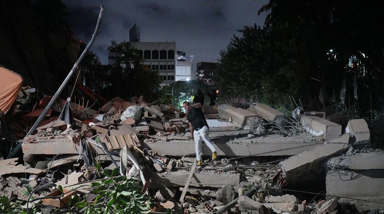 A man jumps on a collapsed building after an earthquake in Caracas, Venezuela, Wednesday, June 24, 2026. (AP Photo/Adrian Naranjo)