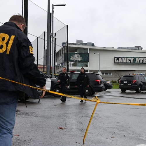 Law enforcement work the scene after a shooting at Laney College in Oakland, Calif., on Thursday, Nov. 13, 2025. (Santiago Mejia/San Francisco Chronicle via AP)