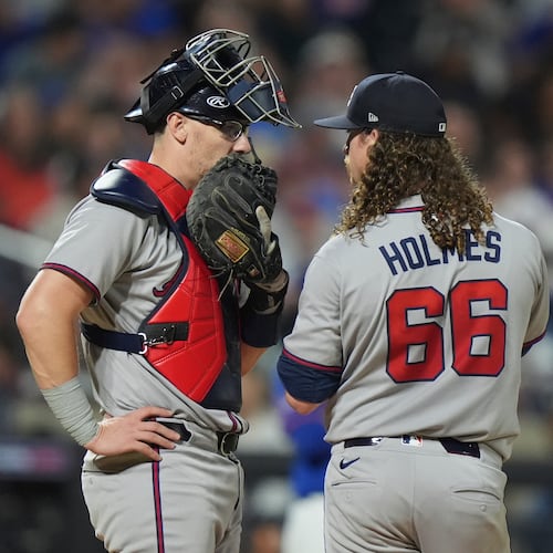 Atlanta Braves catcher Sean Murphy, left, talks to pitcher Grant Holmes during the fifth inning of a baseball game against the New York Mets Thursday, June 26, 2025, in New York. (AP Photo/Frank Franklin II)