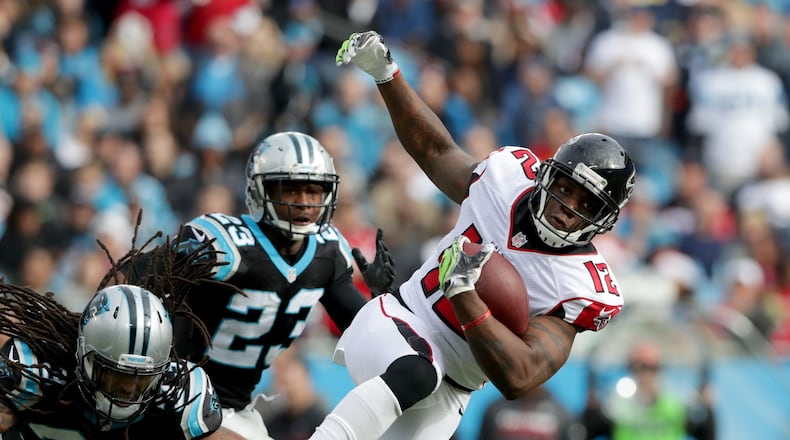 The Falcons’ Mohamed Sanu runs after a catch against Tre Boston (33) and Leonard Johnson of the Panthers in the second quarter during their game at Bank of America Stadium on Dec. 24, 2016 in Charlotte, N.C. (Photo by Streeter Lecka/Getty Images)
