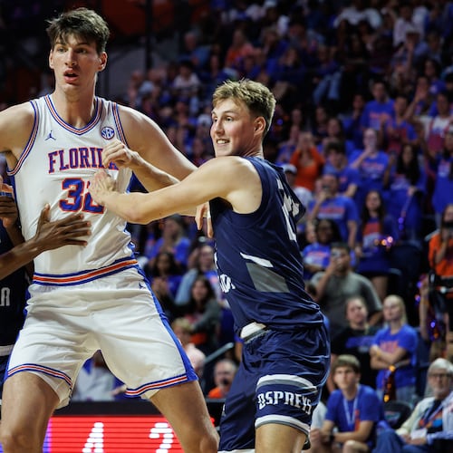 CORRECTS TO SECOND HALF NOT FIRST HALF - North Florida guard Dante Oliver, left and North Florida forward Nestor Dyachok, right, guard against Florida center Olivier Rioux, center, during the second half of an NCAA college basketball game Thursday, Nov. 6, 2025, in Gainesville, Fla. (AP Photo/Chris Watkins)
