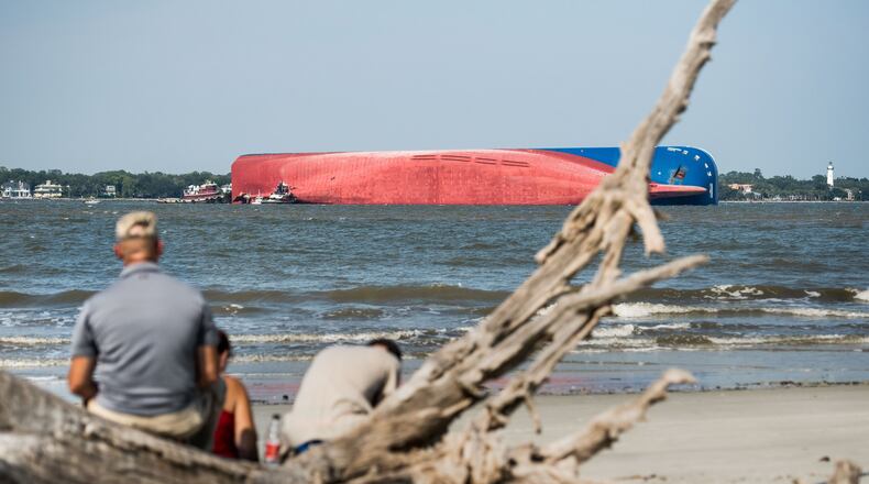 People watch from Jekyll Island as emergency responders work to rescue crew members from a capsized cargo ship on September 9, 2019 in St Simons Island, Georgia. A 656-foot vehicle carrier, the M/V Golden Ray departed the Brunswick port and suffered a fire on board, capsizing in St. Simons Sound. (Photo by Sean Rayford/Getty Images)