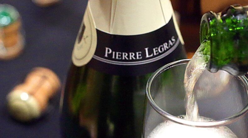 Pouring a glass of Pierre Legras Champagne Grande Cru Brut Blanc de Blancs at West Point Market in Akron, Ohio, on December 15, 2017. (Phil Masturzo/Akron Beacon Journal/TNS)