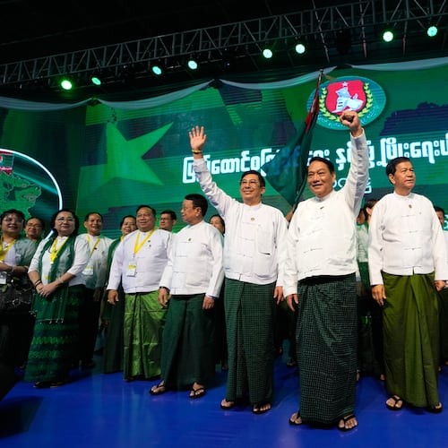 FILE - Khin Yi, center, chairman of the military-backed Union Solidarity and Development Party (USDP), cheers together with the party's members during a ceremony to release the party's election manifesto at Thuwunna indoor stadium Wednesday, Nov. 19, 2025, in Yangon, Myanmar. (AP Photo/Thein Zaw, File)