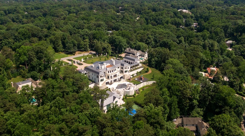 An aerial photo shows a Buckhead neighborhood and the Atlanta skyline. (Hyosub Shin / Hyosub.Shin@ajc.com)