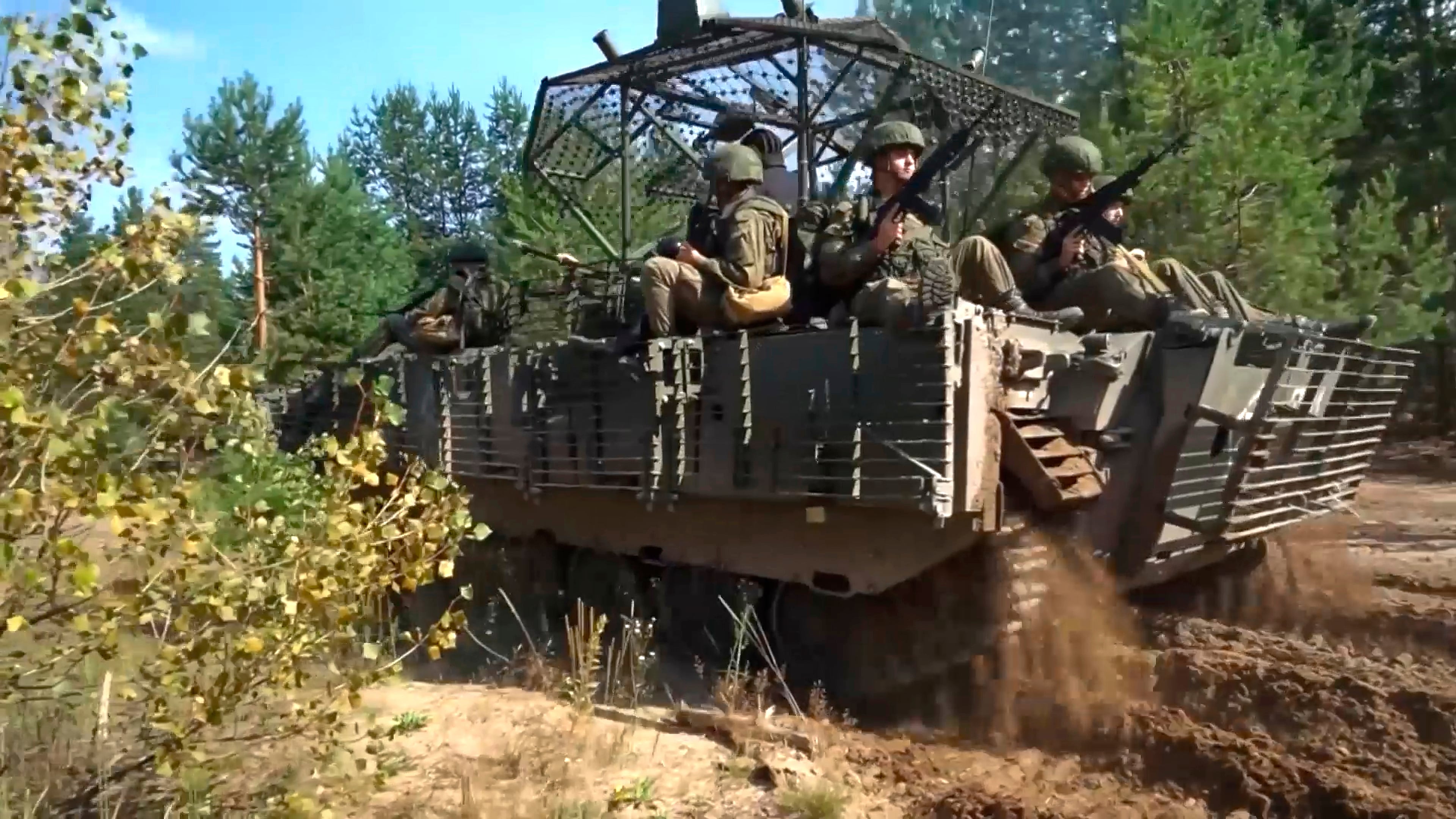 In this photo taken from video distributed by Russian Defense Ministry Press Service on Friday, Sept. 12, 2025, Armored vehicles drive during joint military drills held by Russia and Belarus. (Russian Defense Ministry Press Service via AP)