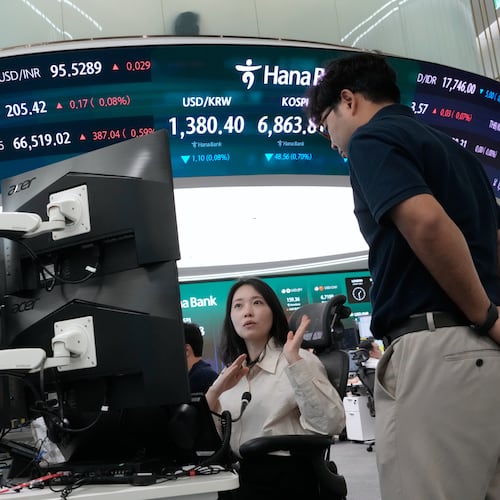 Currency traders work at the foreign exchange dealing room of the Hana Bank headquarters in Seoul, South Korea, Friday, Aug. 28, 2026. (AP Photo/Ahn Young-joon)