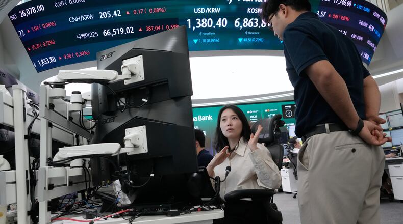 Currency traders work at the foreign exchange dealing room of the Hana Bank headquarters in Seoul, South Korea, Friday, Aug. 28, 2026. (AP Photo/Ahn Young-joon)