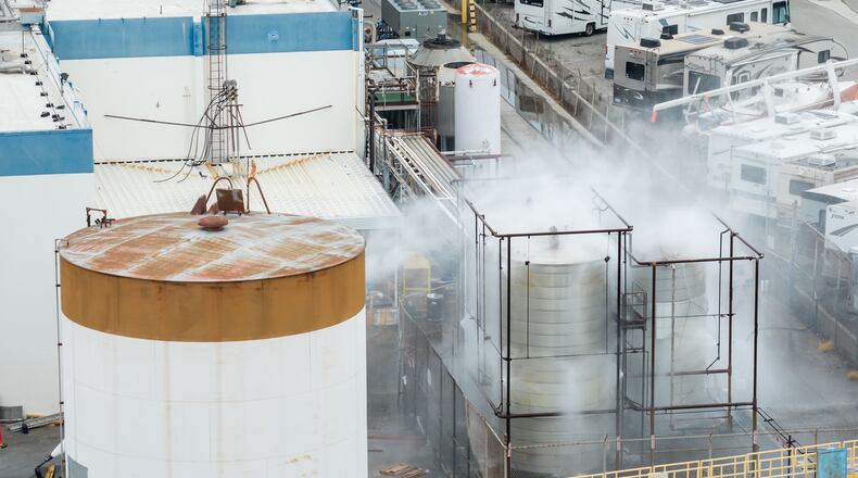 Water is sprayed on a damaged tank at GKN Aerospace in Garden Grove, Calif., on Sunday, May 24, 2026, after the tank containing a chemical used to make plastic parts overheated Thursday. (AP Photo/Ethan Swope)