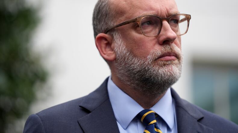 FILE - Office of Management and Budget Director Russell Vought listens to members of the media outside the West Wing at the White House in Washington, Sept. 29, 2025, in Washington. (AP Photo/Evan Vucci, File)