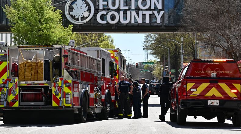 At least four courthouse employees reported symptoms after a package turned up at the Fulton County Courthouse on Friday.
