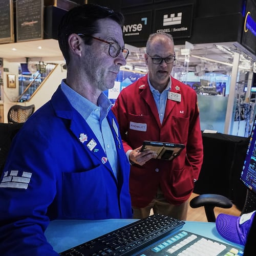 Specialist John McNierney, left, and trader William Lawrence work on the floor of the New York Stock Exchange, Wednesday, June 3, 2026. (AP Photo/Richard Drew)