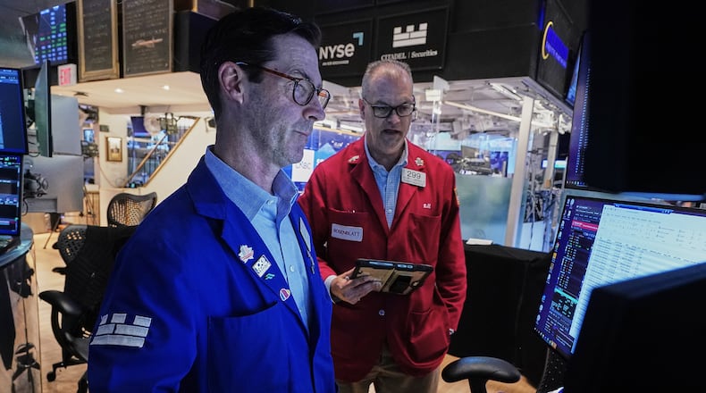 Specialist John McNierney, left, and trader William Lawrence work on the floor of the New York Stock Exchange, Wednesday, June 3, 2026. (AP Photo/Richard Drew)