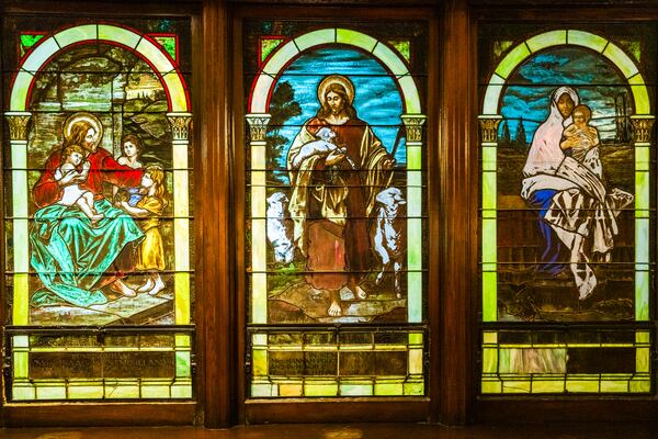 The triptych on display inside of First Congregational Church is comprised of individual panes dedicated to families connected to the church's history. The stained glass windows were first installed in 1909. (Ronald Williams/AJC)