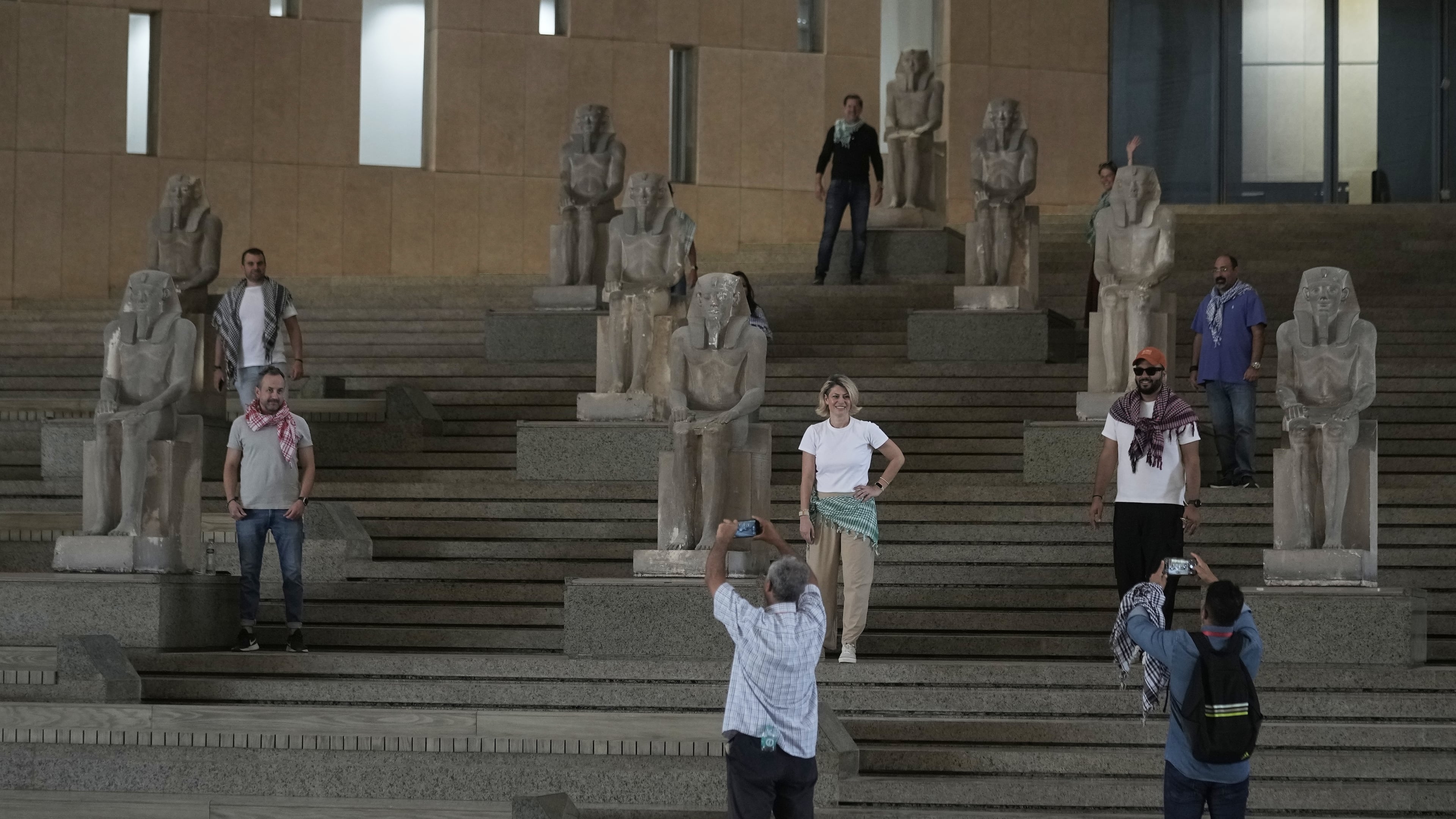 Tourists pose at the Grand staircase at the Grand Egyptian Museum in Giza, Egypt, Friday, May 23, 2025. (AP Photo/Amr Nabil)