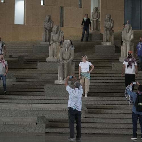 Tourists pose at the Grand staircase at the Grand Egyptian Museum in Giza, Egypt, Friday, May 23, 2025. (AP Photo/Amr Nabil)