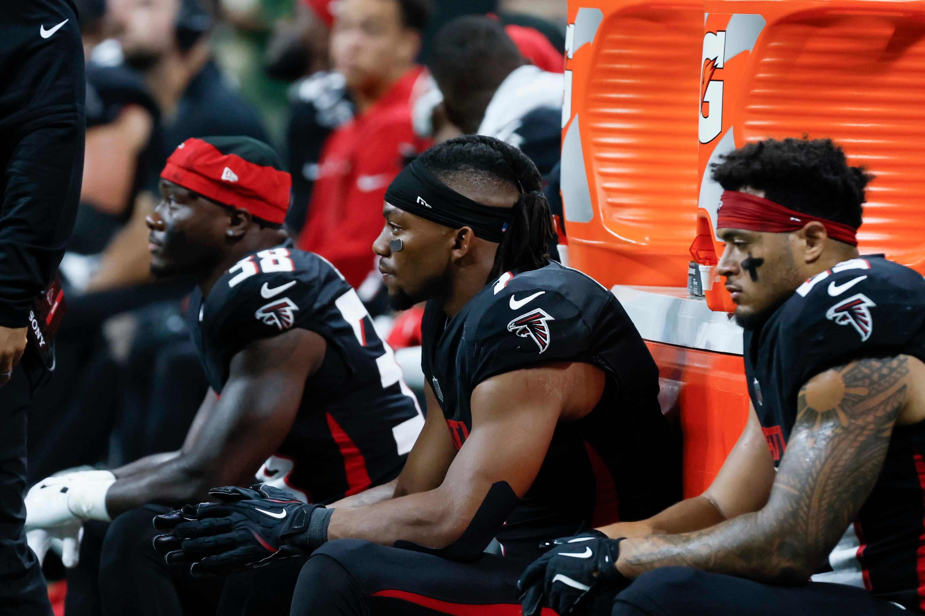 Atlanta Falcons running back Bijan Robinson (center) and running back Tyler Allgeier (right), along with running back Nate Carter (left), are seen sitting quietly during the second half of an NFL football game against the Miami Dolphins at Mercedes-Benz Stadium in Atlanta on Sunday, Oct. 26, 2025. (Miguel Martinez/AJC)