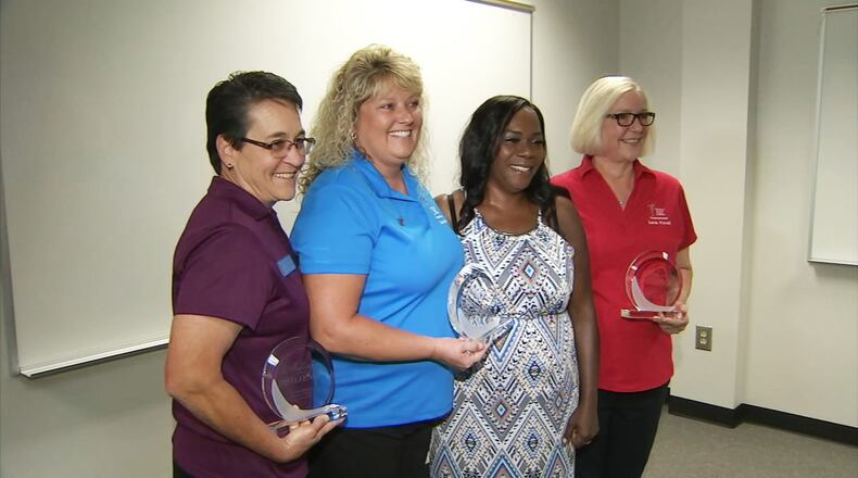 From left: Bus drivers Cindy Johnston and Sandy Purcell along with Dee Walls (far right) used CPR to save the life of co-worker Felina Canon (in the dress) at a training class earlier this month. WSBTV