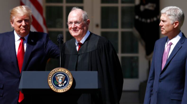 President Donald Trump, left, Supreme Court Justice Anthony Kennedy, center, and Justice Neil Gorsuch participate in a public swearing-in ceremony for Gorsuch in the Rose Garden of the White House White House in Washington, Monday, April 10, 2017. (AP Photo/Carolyn Kaster)