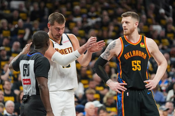 Denver Nuggets center Nikola Jokic, center, talks with referee James Williams (60) as Oklahoma City Thunder's Isaiah Hartenstein (55) looks on in the second half of Game 2 in the conference semifinals of the NBA basketball playoffs, Wednesday, May 7, 2025, in Oklahoma City. (AP Photo/Kyle Phillips)