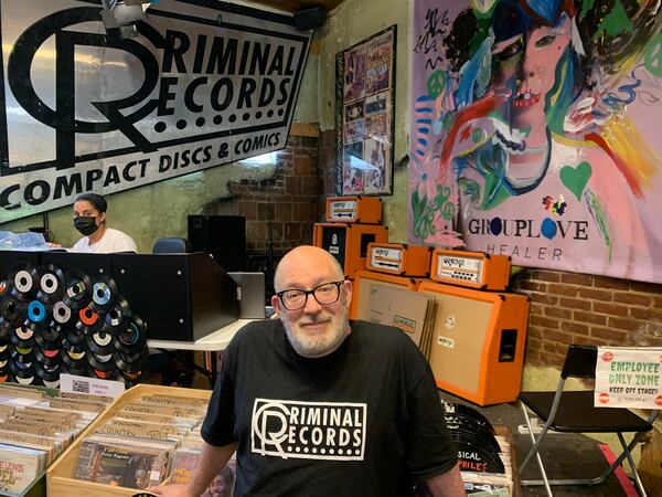 Eric Levin, owner of Criminal Records, in front of the stage at his store on July 31, 2021. RODNEY HO/rho@ajc.com