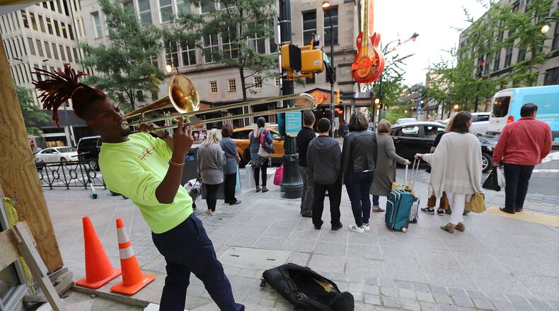 October 16, 2019 Atlanta: Street performer Eryk D. Radical, 26, a legally blind Georgia State University student, plays his trombone for pedestrians on Peachtree Street at Andrew Young International Boulevard in Atlanta. Radical is suing Atlanta police, MARTA police and the Fulton County Sheriff’s office alleging repeated harassment while playing on street corners. Curtis Compton/ccompton@ajc.com