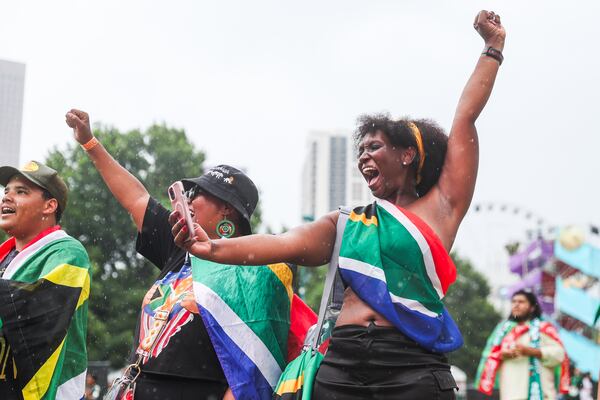 South Africa fans sing the national anthem in the rain before the South Africa vs. Czechia World Cup game during the FIFA Fan Festival at Centennial Olympic Park in Atlanta on Thursday, June 18, 2026. (Abbey Cutrer/AJC)