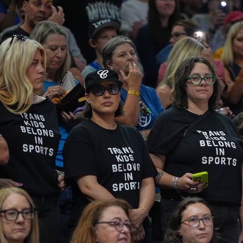 Fans wear shirts saying "Trans Kids Belong In Sports" during a WNBA basketball game between the Minnesota Lynx and the Indiana Fever Sunday, Aug. 2, 2026, in Minneapolis. (AP Photo/Abbie Parr)