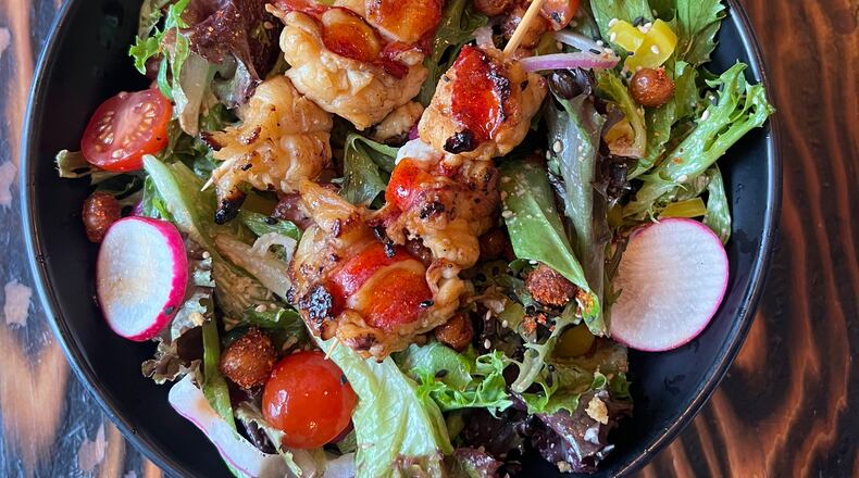 This kona salad at Yakitori Kona has lobster skewers grilled over binchotan charcoal. (Angela Hansberger for The Atlanta Journal-Constitution)