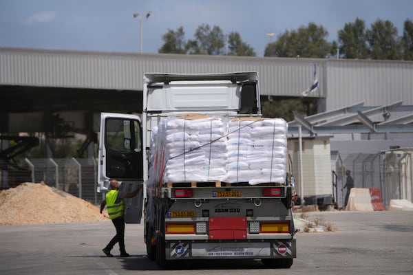 Trucks carrying humanitarian aid for the Gaza Strip are seen at the Kerem Shalom Crossing in southern Israel, Monday, May 19, 2025. A day after Israel said it would resume allowing aid into the territory. (AP Photo/Ohad Zwigenberg)