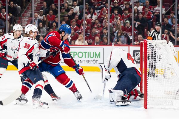 Montreal Canadiens' Juraj Slafkovsky, third from left, is stopped by Washington Capitals goaltender Logan Thompson, right, during the first period of Game 3 of a first-round NHL hockey playoff series in Montreal Friday, April 25, 2025. (Christopher Katsarov/The Canadian Press via AP)