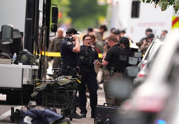 Law enforcement officials investigate after an attack on the Pearl Street Mall Sunday, June 1, 2025, in Boulder, Colo. (AP Photo/David Zalubowski)