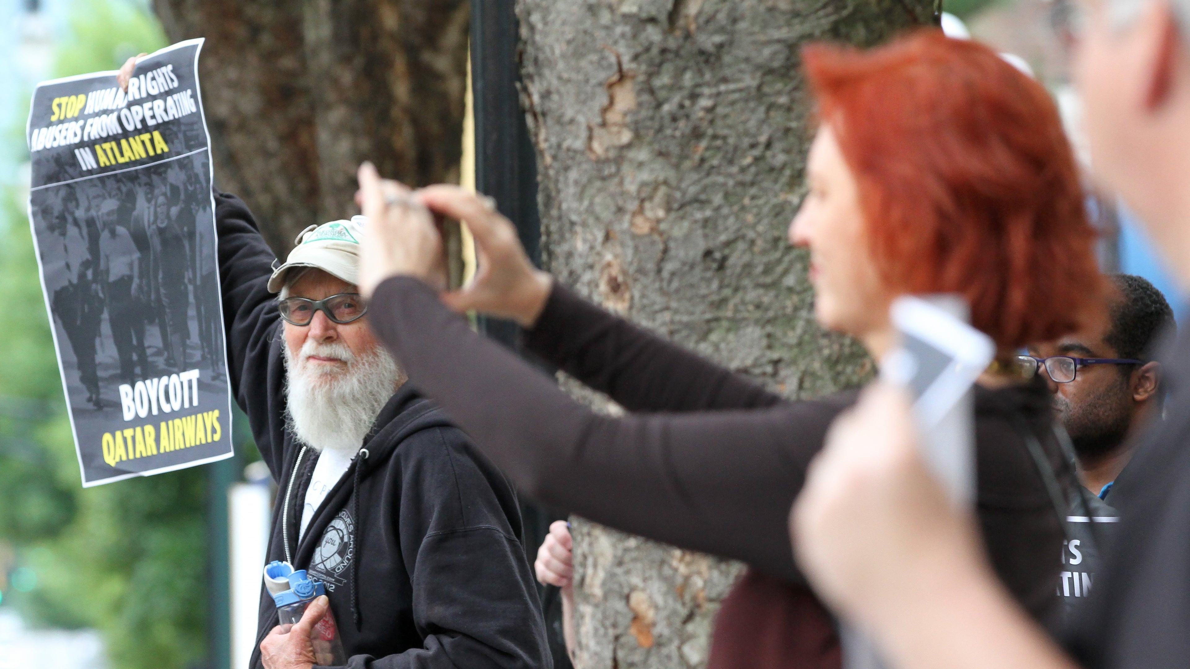In 2016, Tom Coffin joined a small group protesting that Qatar Airways was adding a new route to Atlanta. (Ben Gray/AJC)