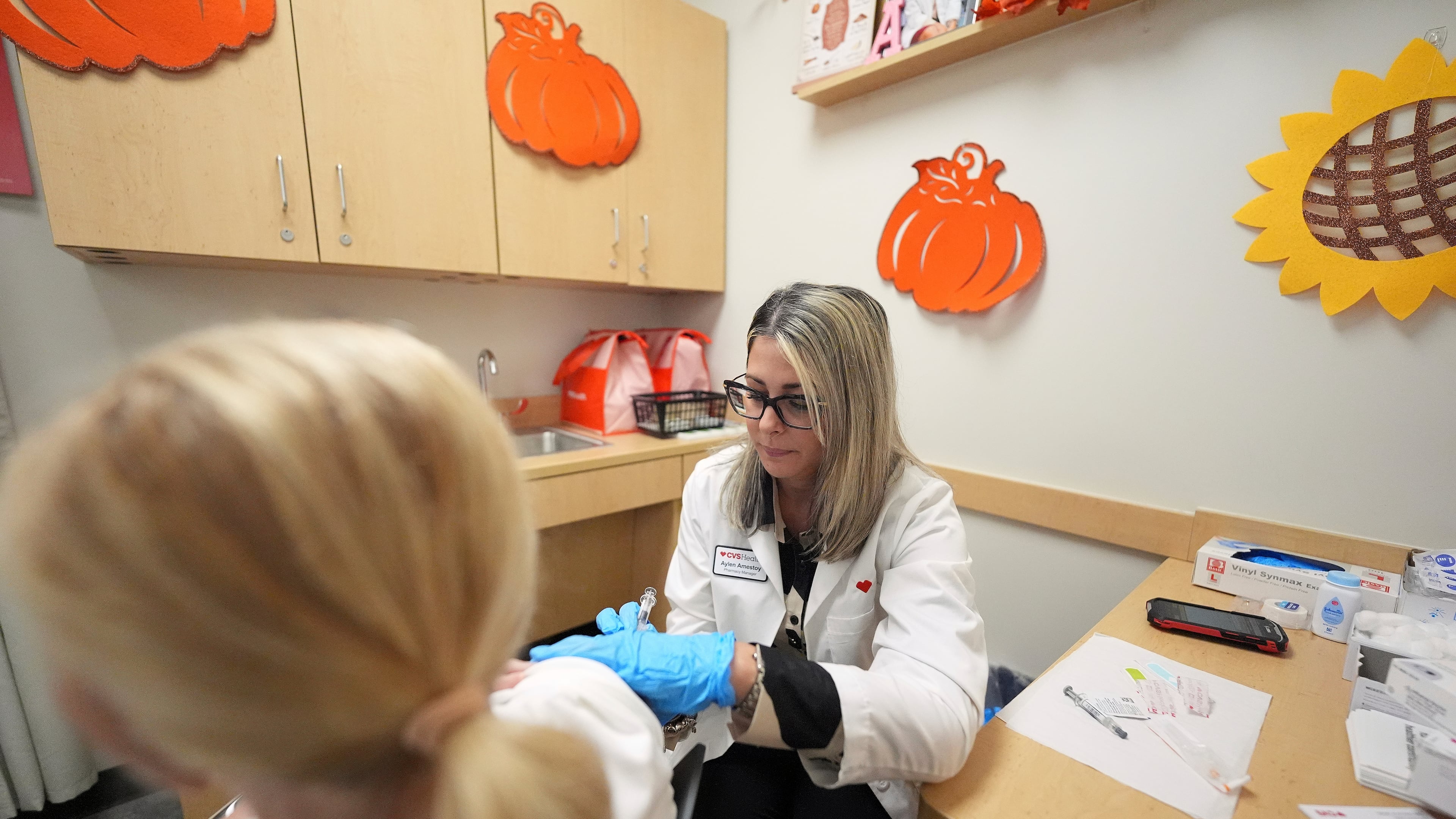 Pharmacy manager Aylen Amestoy administers a patient with a COVID-19 vaccine at a CVS Pharmacy in Miami, Tuesday, Sept. 9, 2025. (AP Photo/Rebecca Blackwell)