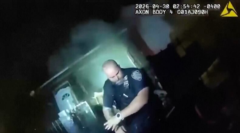 This image made from New York Police Department body camera video shows an officer after an explosion at a house while responding to a call of an armed man Thursday, April 30, 2026, in the Queens borough of New York. (New York Police Department via AP)