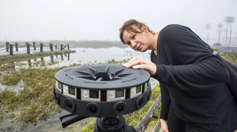 Juliette Finzi Hart with the U.S. Geological Survey, sets up a 360 degree video camera made by Google to record a high tide in the Bolsa Chica wetlands early Thursday morning, Feb. 9, 2017, in Huntington Beach, Calif. (Mark Rightmire/Orange County Register/TNS)