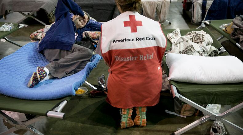 Volunteer Lisa Black comforts Janice Forse at the emergency shelter at the Beaumont Civic Center in Beaumont after Hurricane Harvey on Wednesday August 30, 2017. Her home in Beaumont was flooded Wednesday morning. "Even Katrina wasn't this bad," she said.