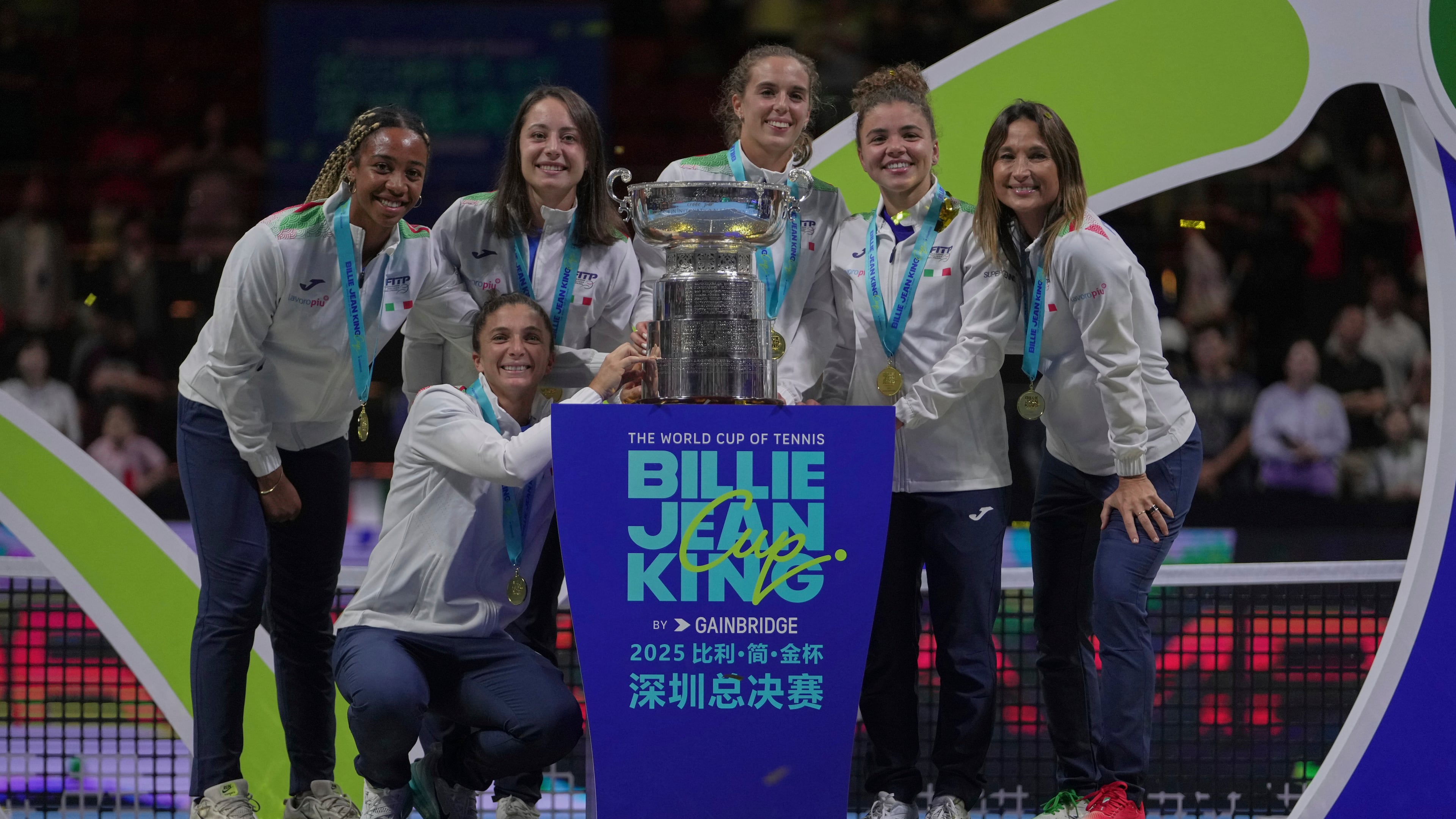 Italy's tennis team pose with the trophy on podium after winning the Billie Jean King Cup final against the United States, at the Shenzhen Bay Sports Center Arena, in Shenzhen, China's Guangdong province, Sunday, Sept. 21, 2025. (AP Photo/Andy Wong)