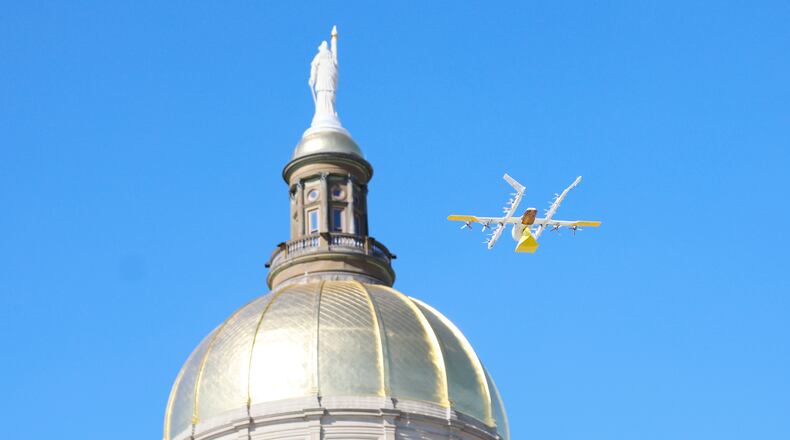 A drone from Wing, a delivery company, is seen flying beside the Gold Dome with a package in Atlanta during a demonstration at Liberty Plaza on Tuesday, Feb. 4, 2025. (Miguel Martinez/ AJC)