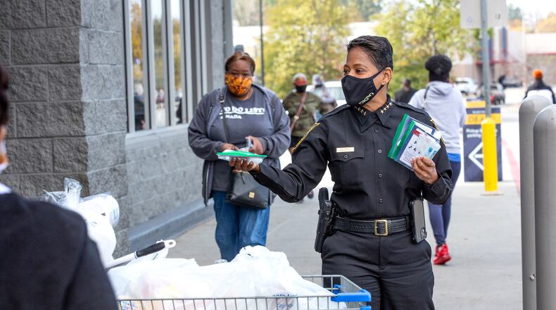 DeKalb Police Chief Mirtha Ramos hands out some of the 10,000 COVID-19 care kits at a Lithonia Walmart on November 25, 2020.     STEVE SCHAEFER / SPECIAL TO THE AJC